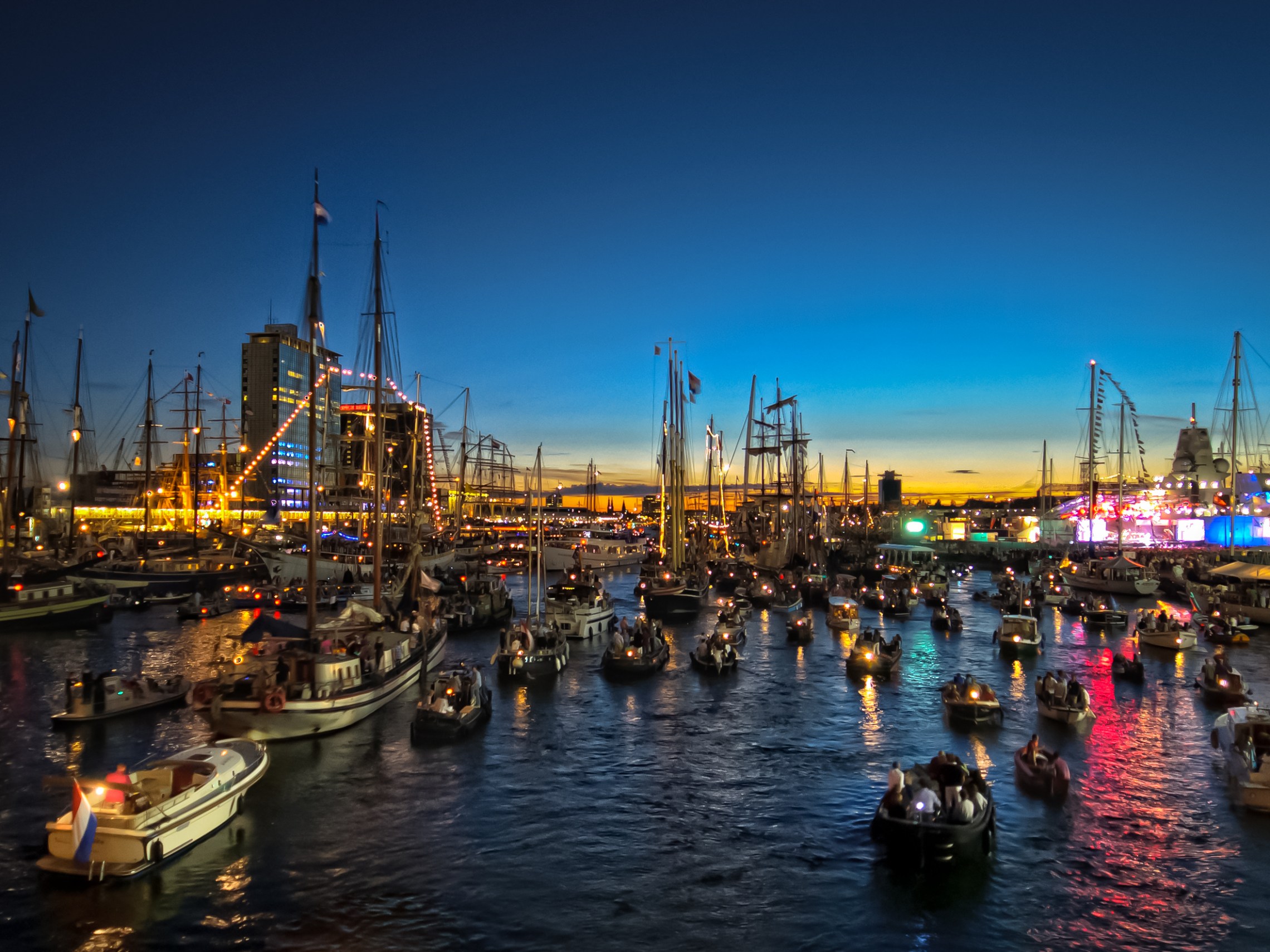 a harbor filled with lots of small boats in a body of water
