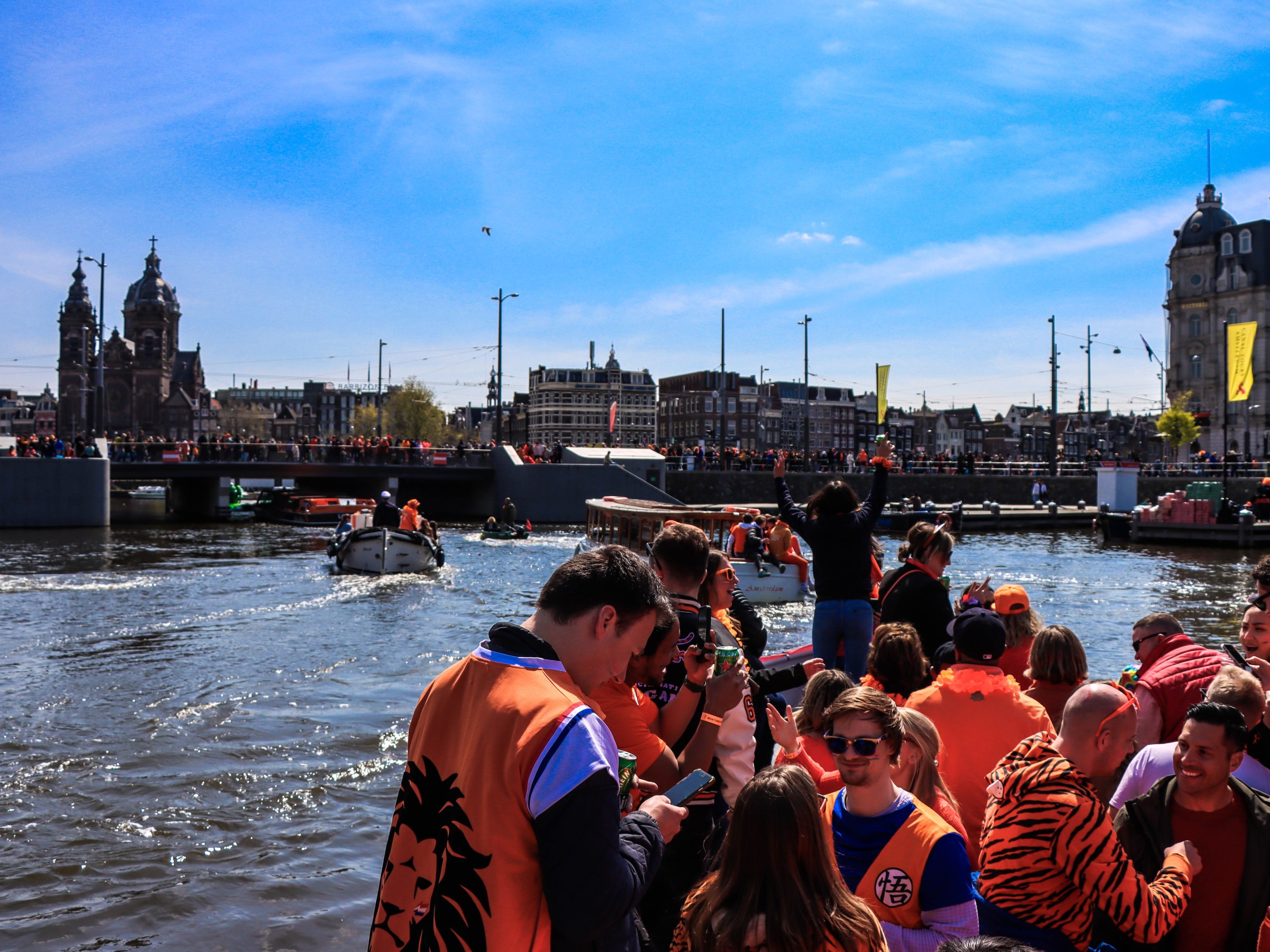a group of people standing next to a body of water