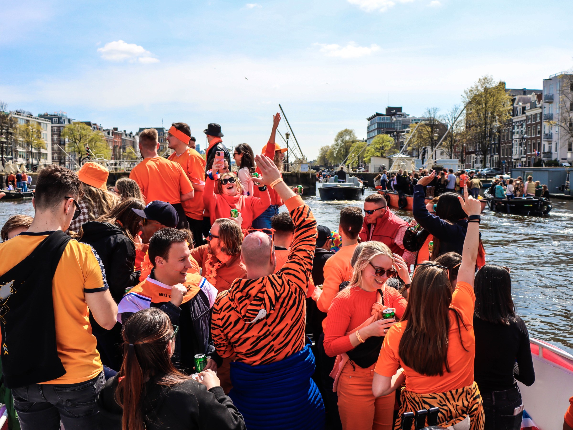 a group of people standing next to a body of water