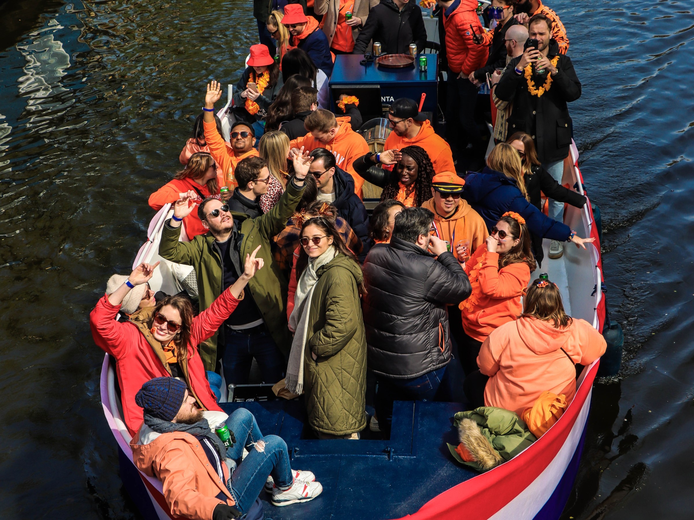 a group of people in a small boat in a body of water