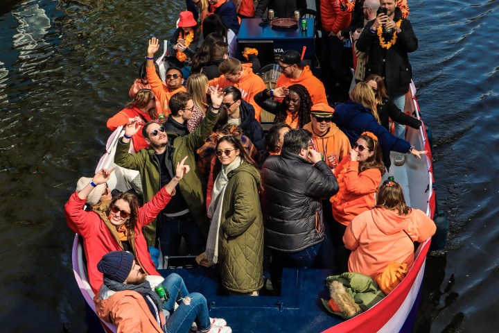 a group of people in a small boat in a body of water