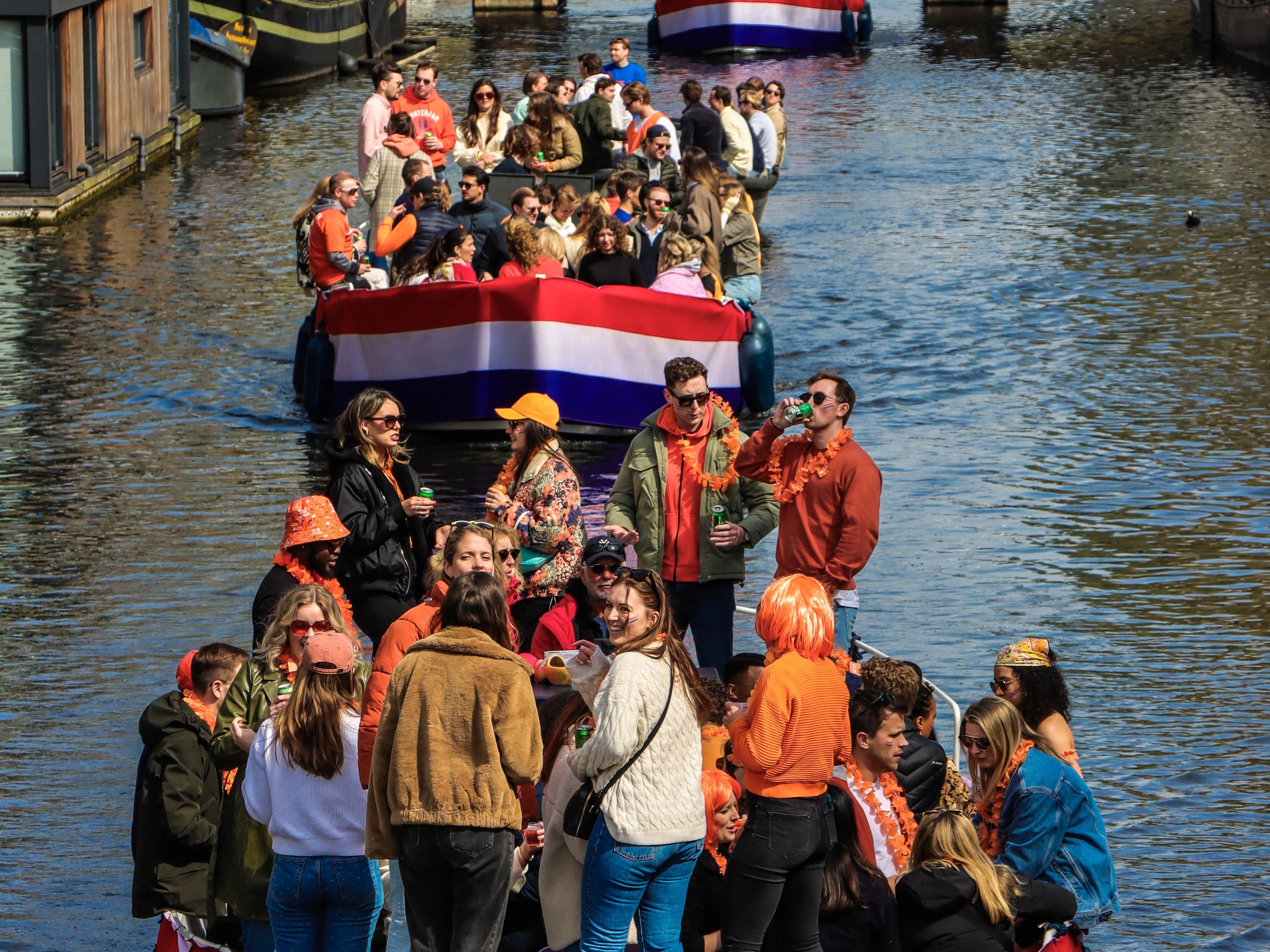 a group of people in a small boat in a large body of water